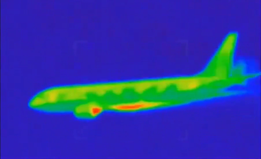 Drone thermal-style still showing apparent hotspots on the aircraft-like target and orb-like objects